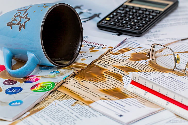 "Spilled coffee on  desk items."